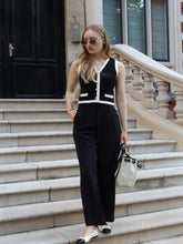 A lady wears a black vest.